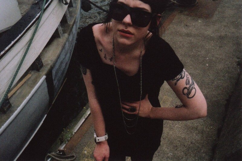 person with tattoos near boats