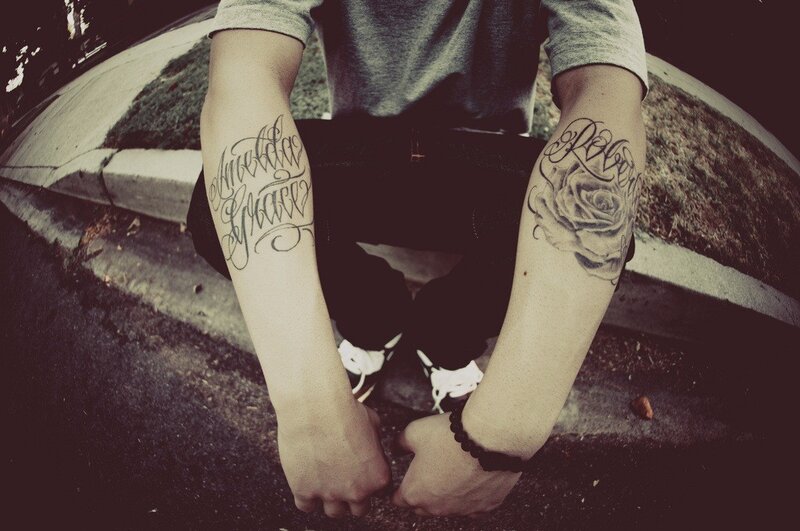 person with tattoos on arms