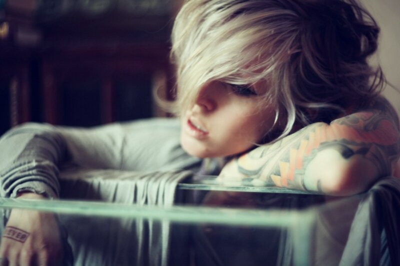 person with tattoos resting