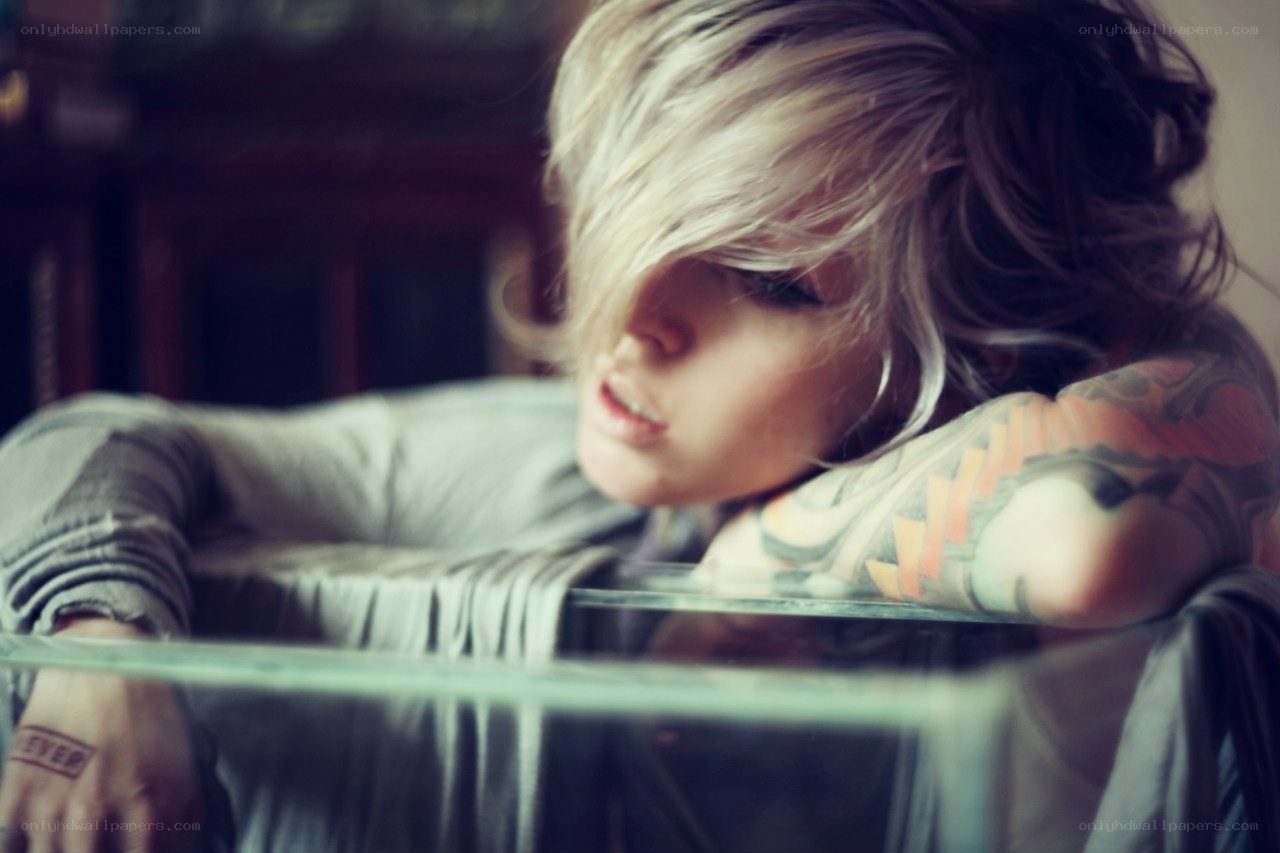 person with tattoos resting