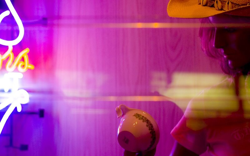 person with teapot in neon light