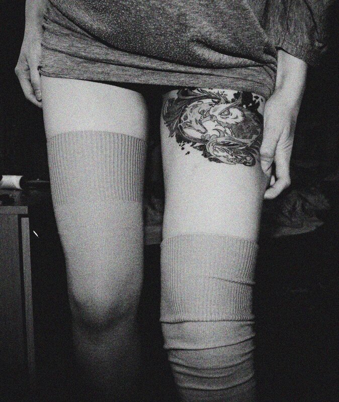 person with thigh tattoo