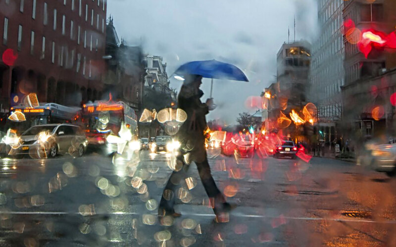 Person with Umbrella Crossing Street