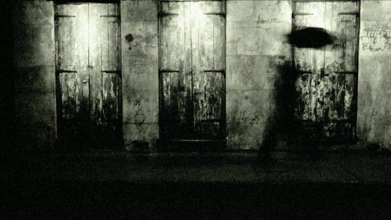 person with umbrella in alley