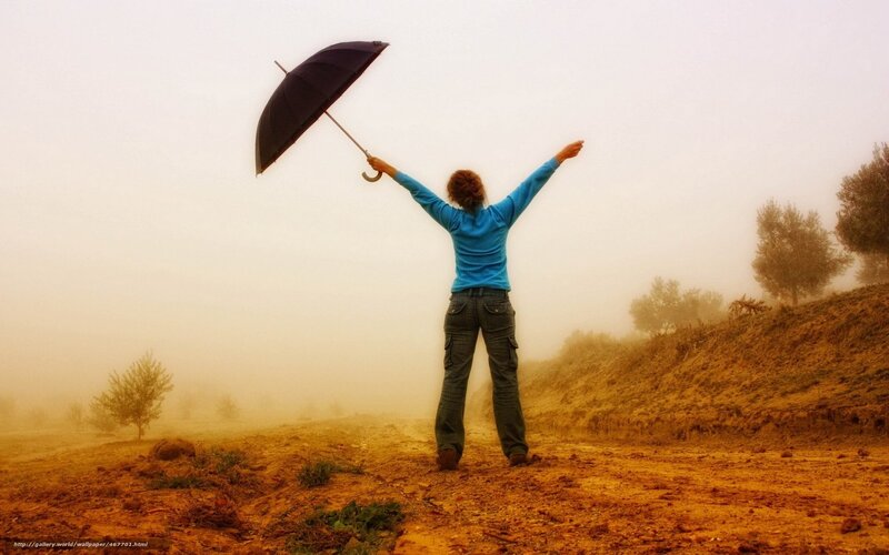 Person with umbrella in fog