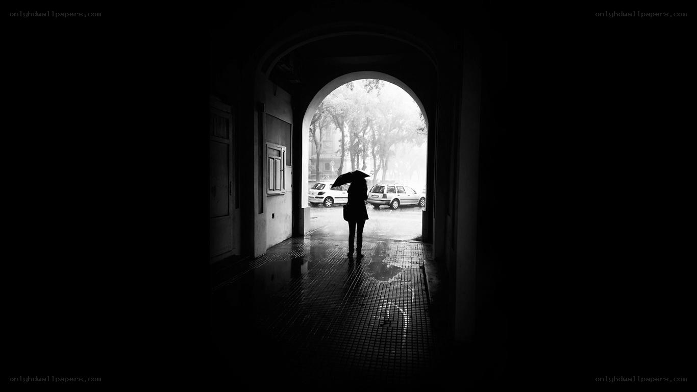 person with umbrella in tunnel