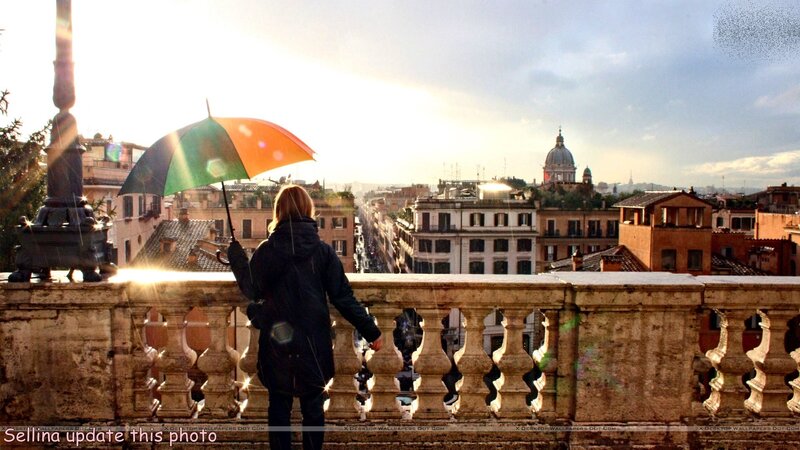 Person with Umbrella on Balcony