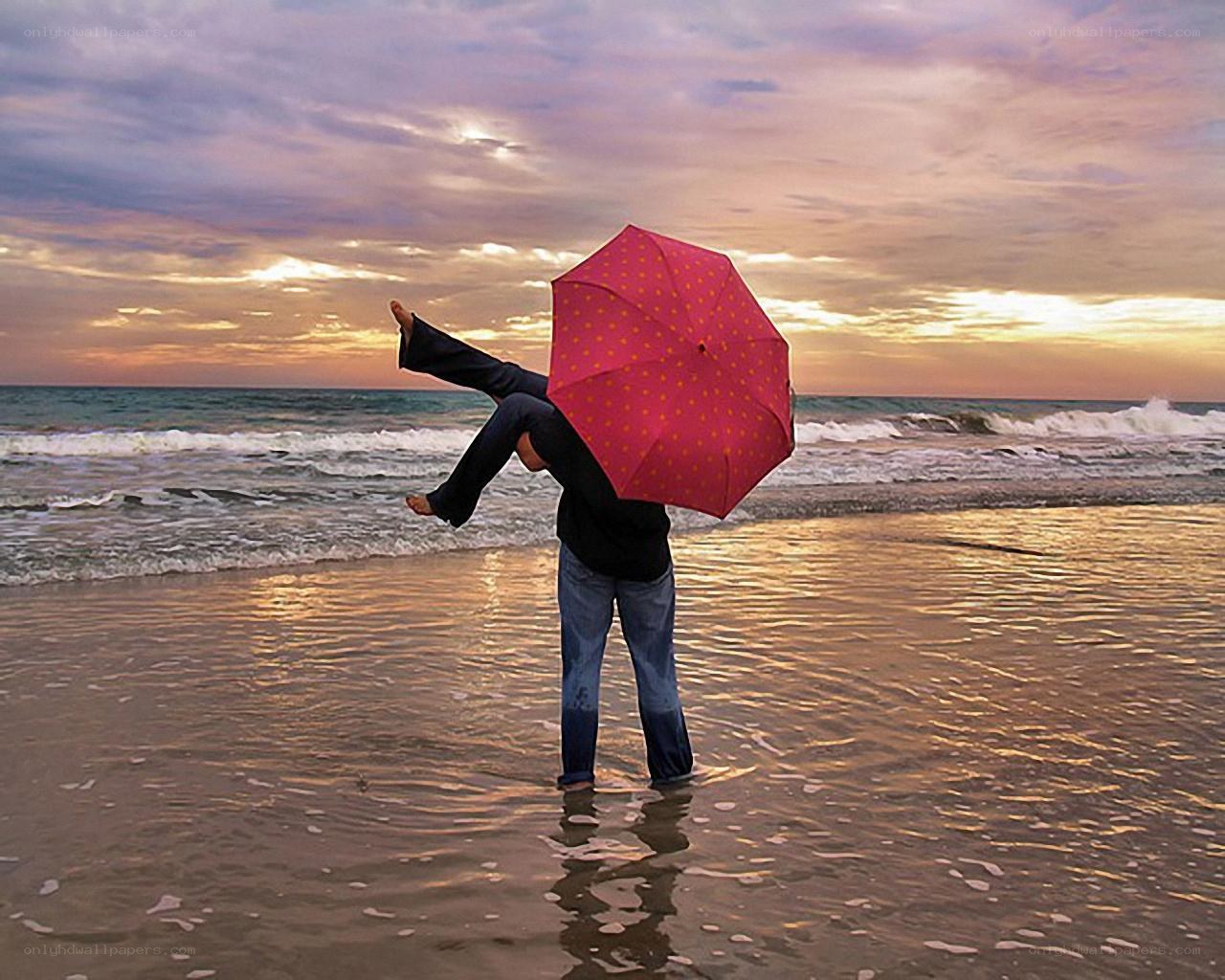 Person with umbrella on beach
