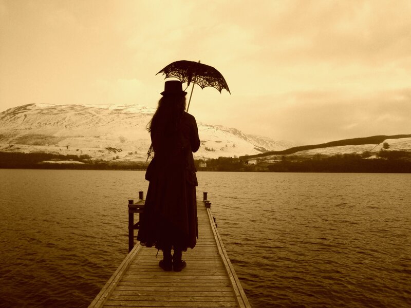 person with umbrella on dock