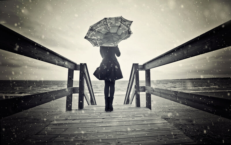 Person with Umbrella on Pier