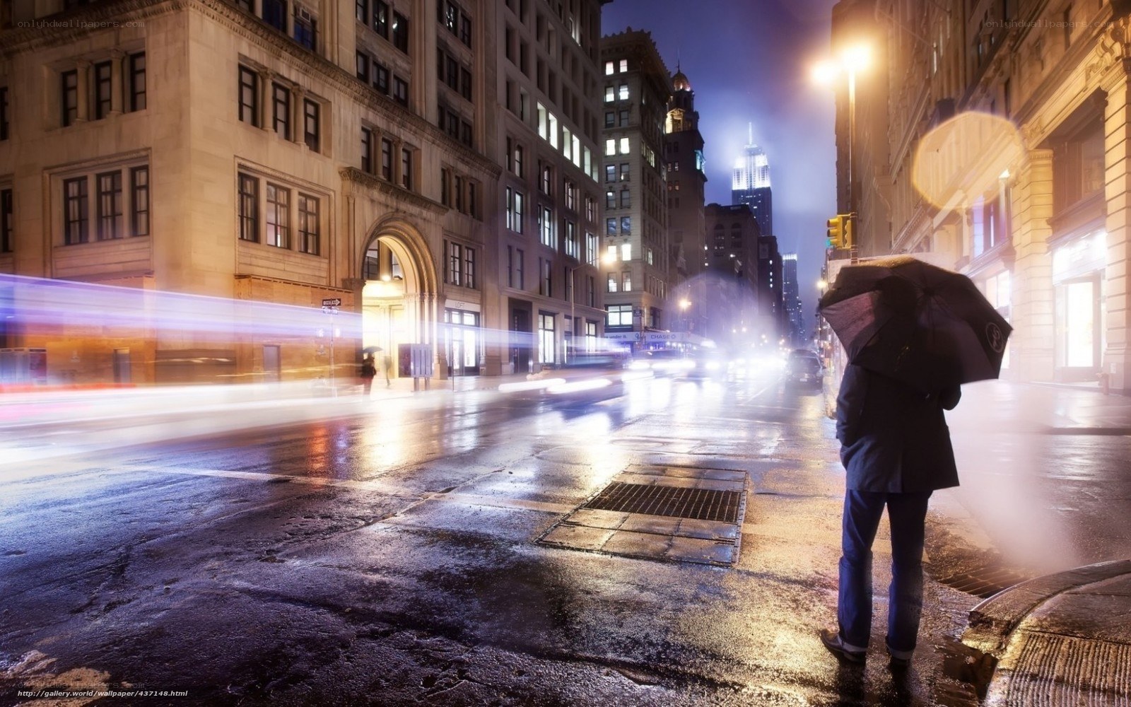 Person with umbrella on rainy street