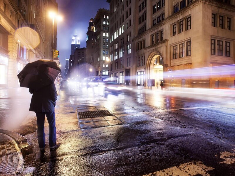 Person with umbrella on rainy street