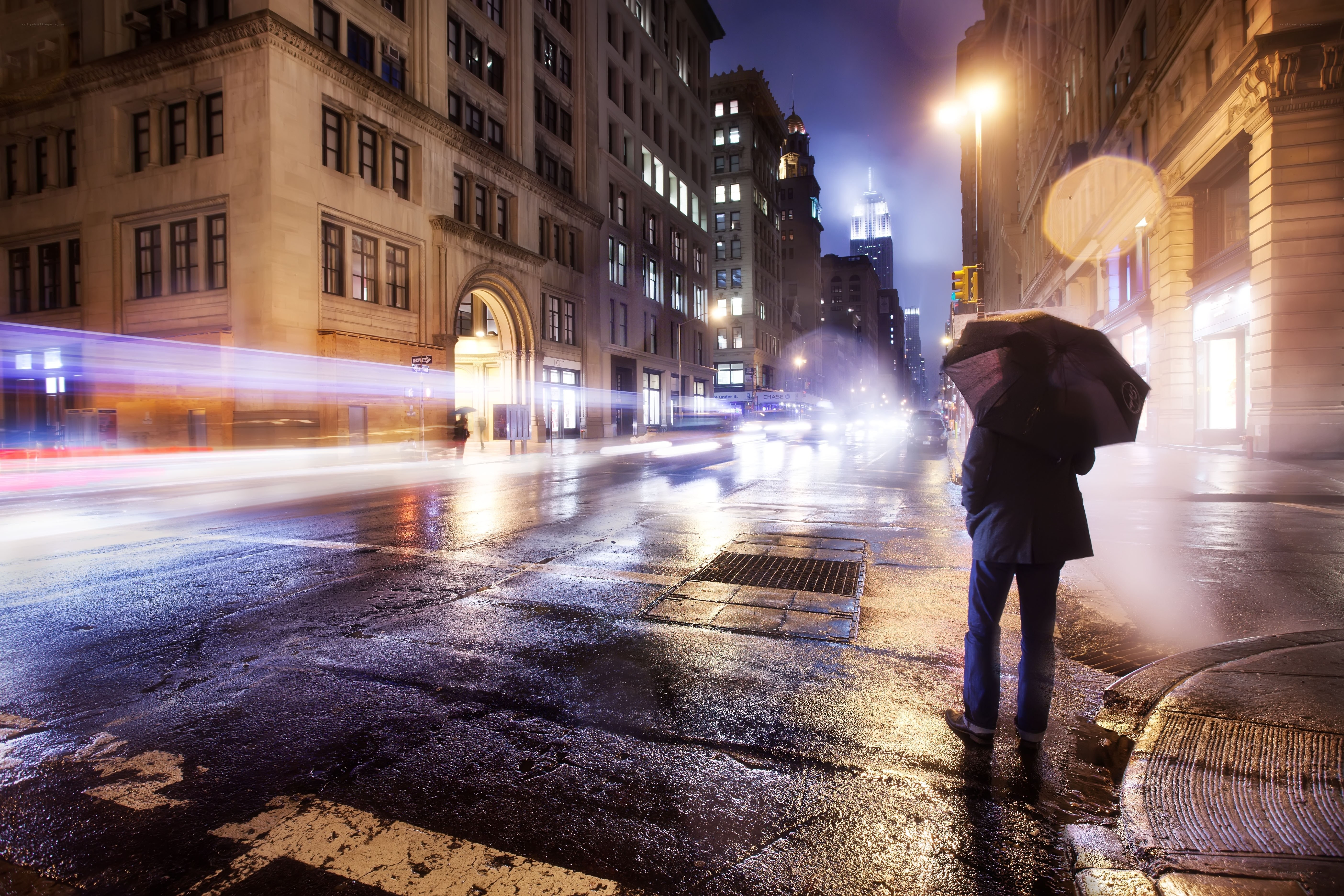 Person with umbrella on rainy street