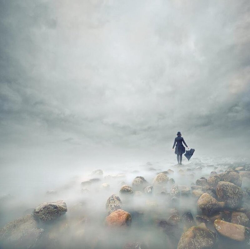 Person with Umbrella on Rocks — Gray
