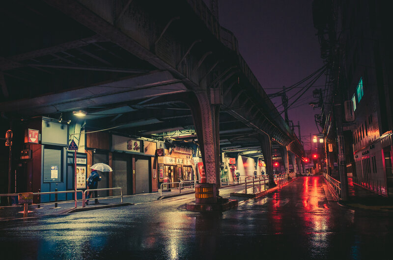 Person with Umbrella under Bridge