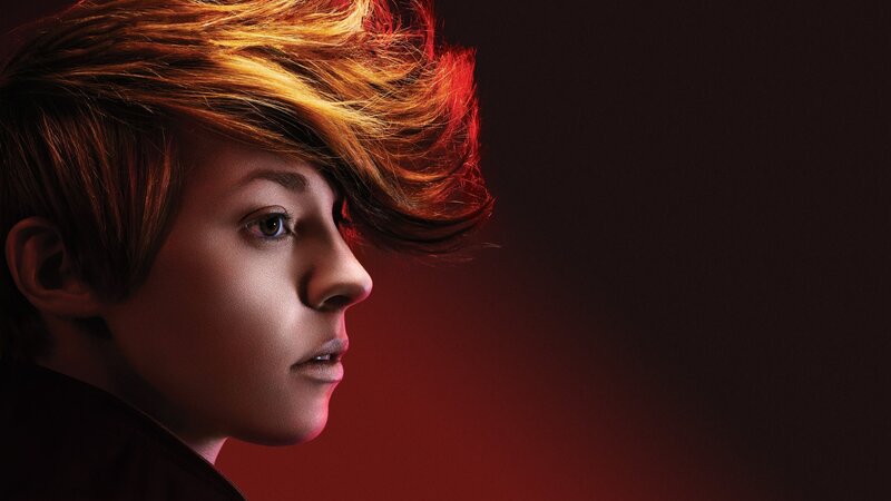person with vibrant hair in profile