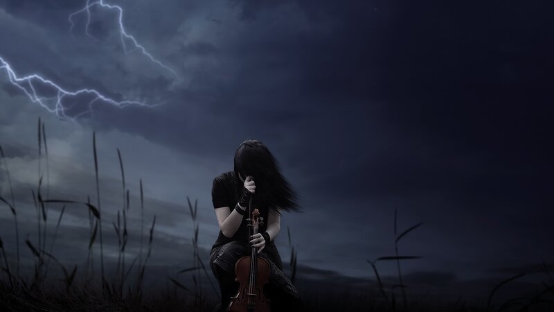 Person with violin in storm