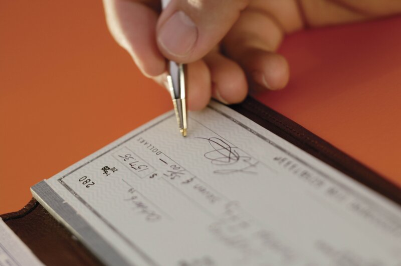 Person writing a check