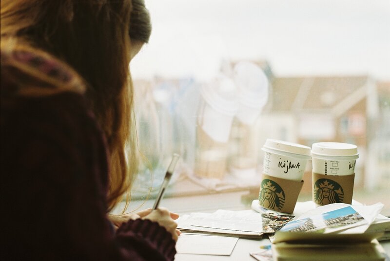 Person Writing at Table