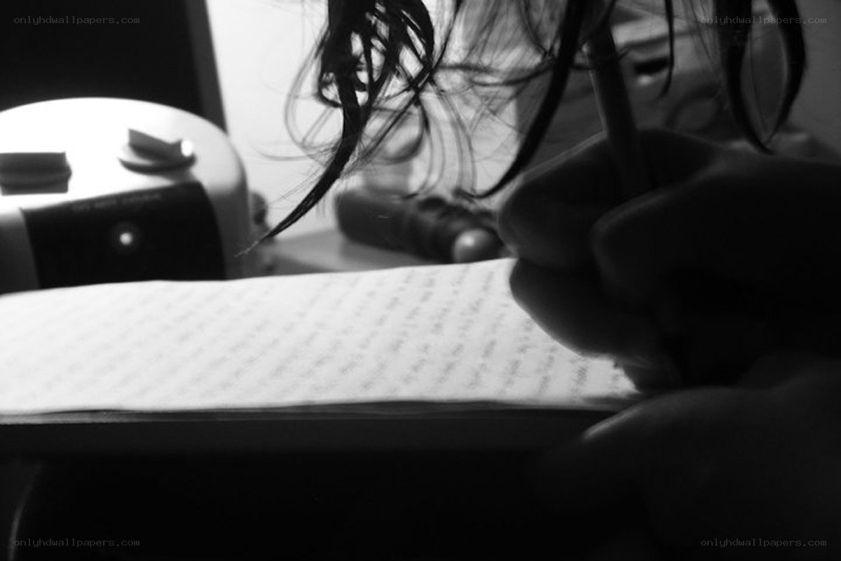 person writing in a notebook