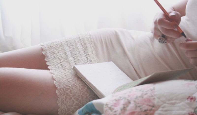 person writing in a notebook