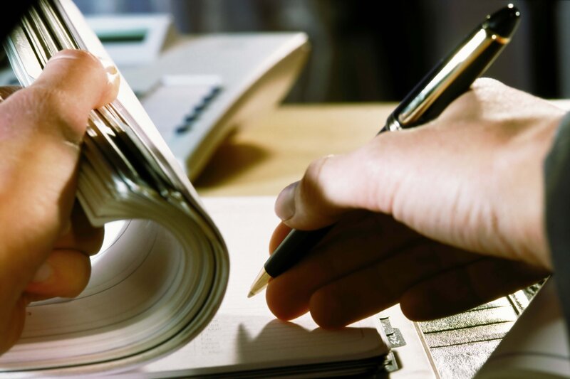 Person writing in notebook