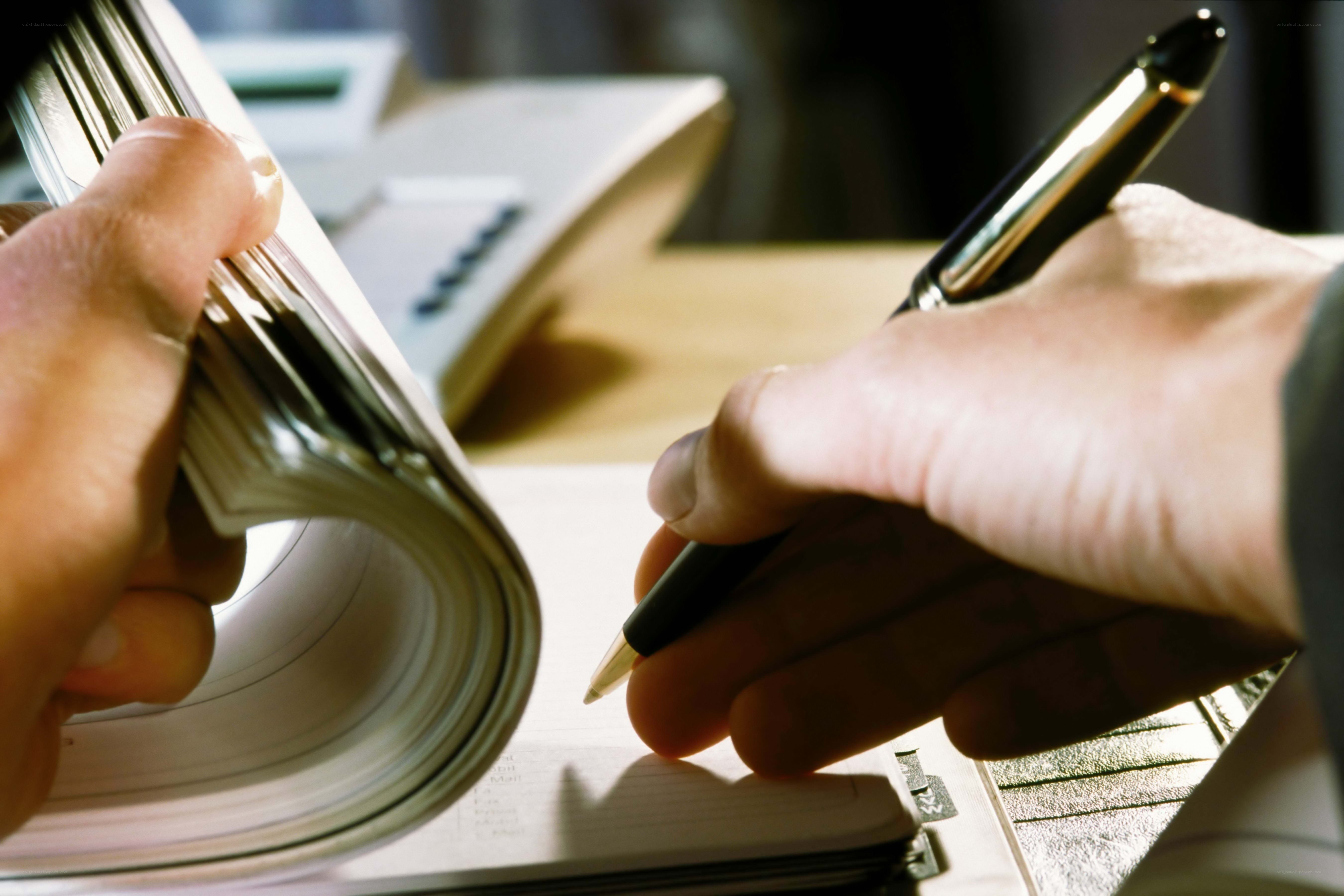 Person writing in notebook