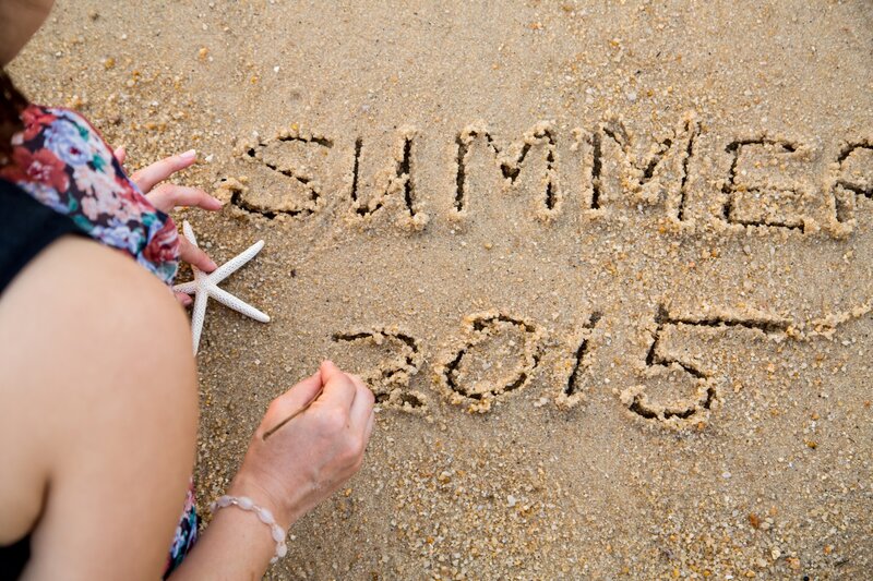 Person Writing on Sand