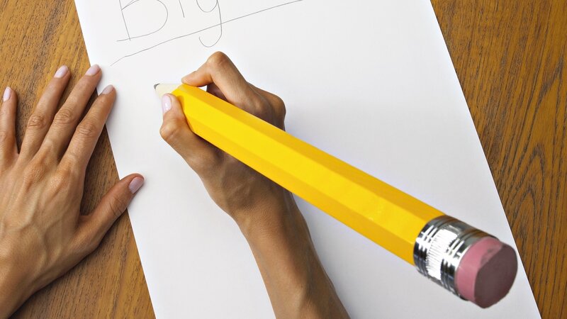 Person Writing with Giant Pencil — Yellow