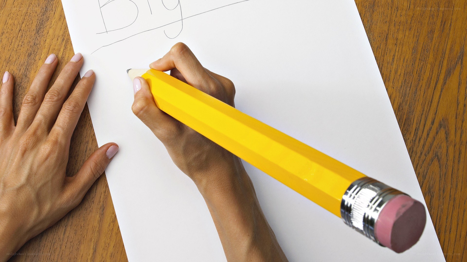 person writing with giant pencil