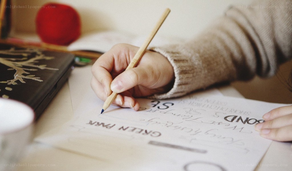 Person writing with pencil
