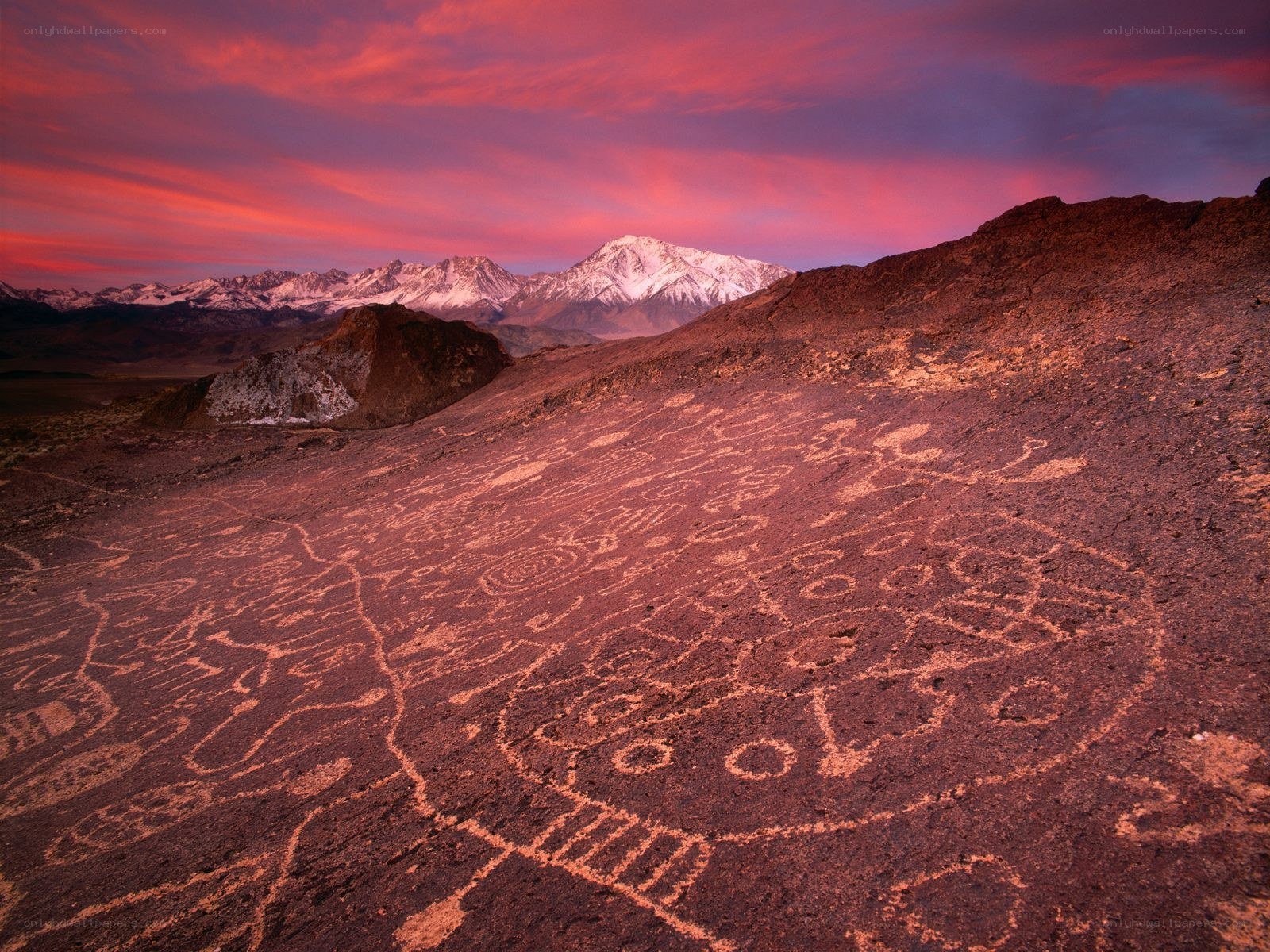 Petroglyphs at sunset with mountains