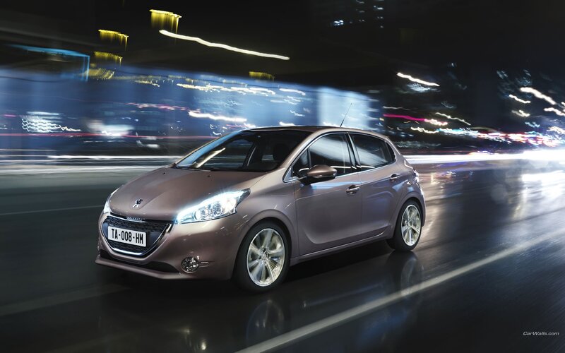Peugeot 208 in motion at night