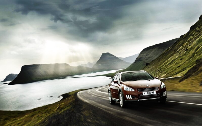 Peugeot car on coastal road