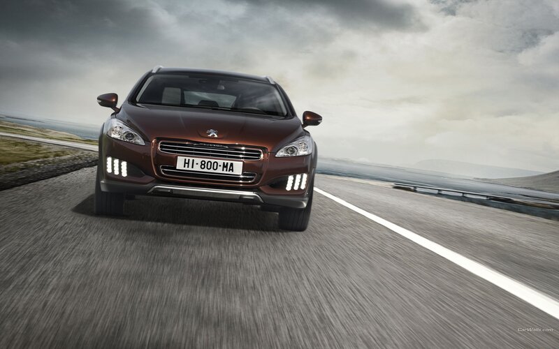 Peugeot driving on coastal road