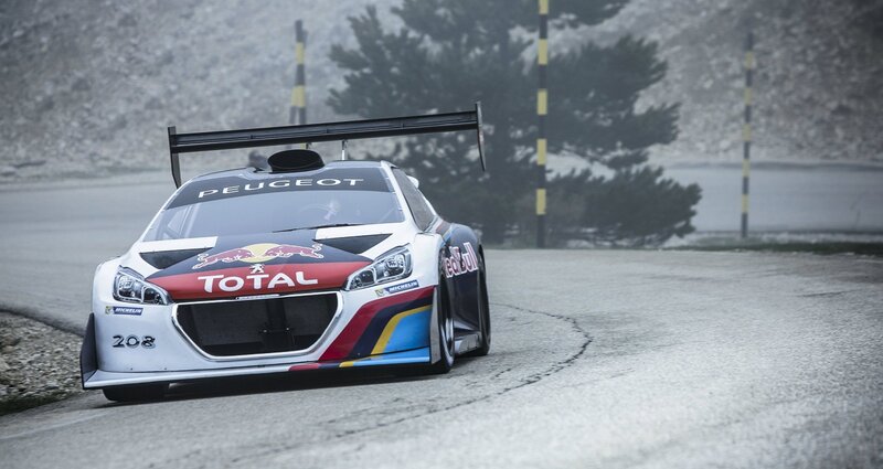 Peugeot rally car on a winding road