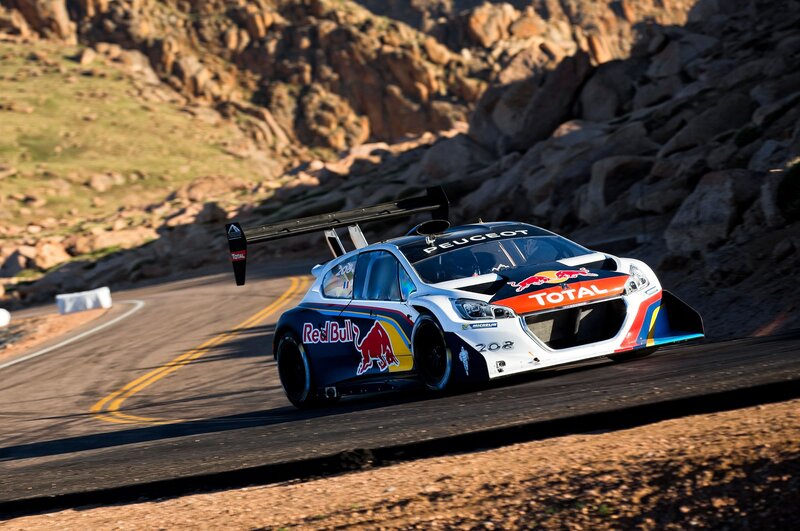 Peugeot rally car on mountain road