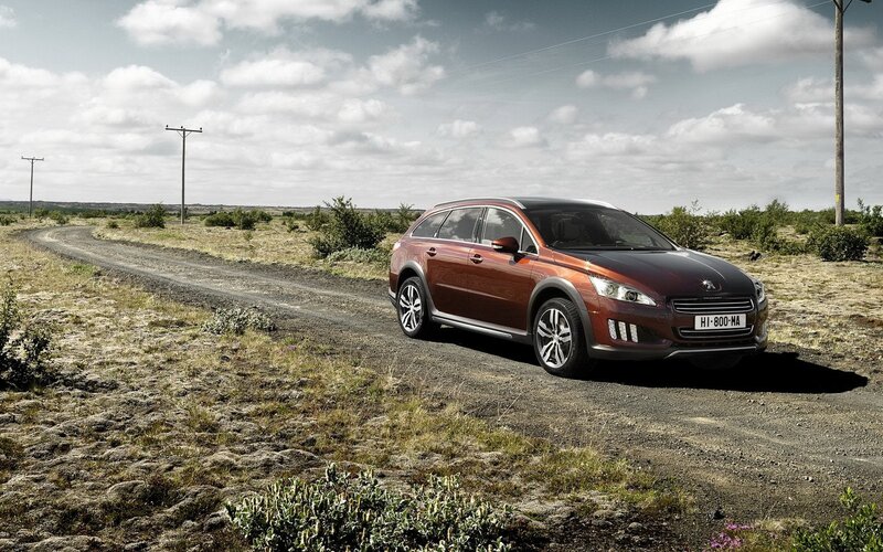 Peugeot station wagon on dirt road