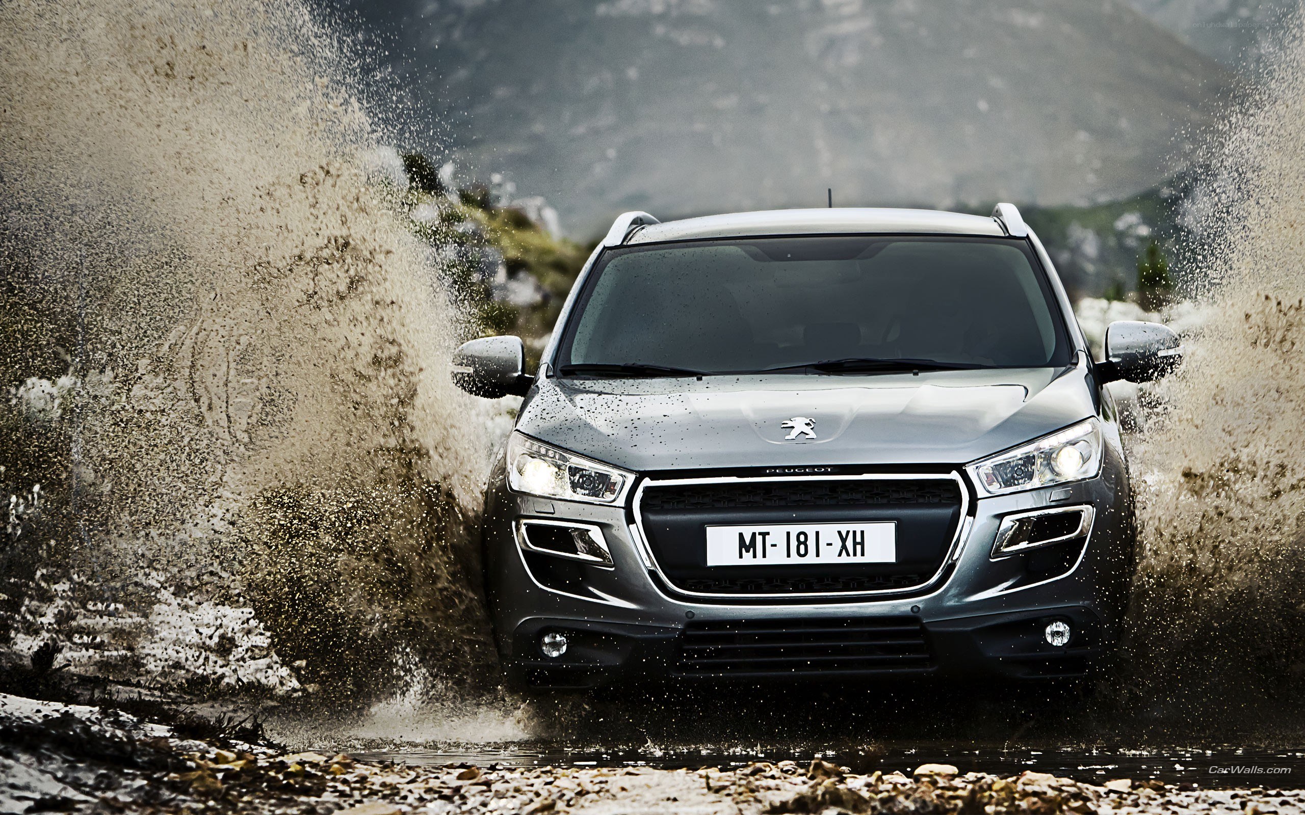 Peugeot SUV splashing through mud