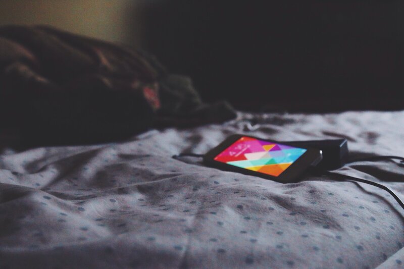 phone charging on bed
