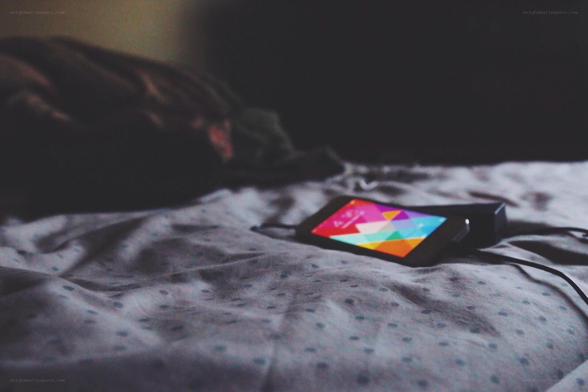 phone charging on bed