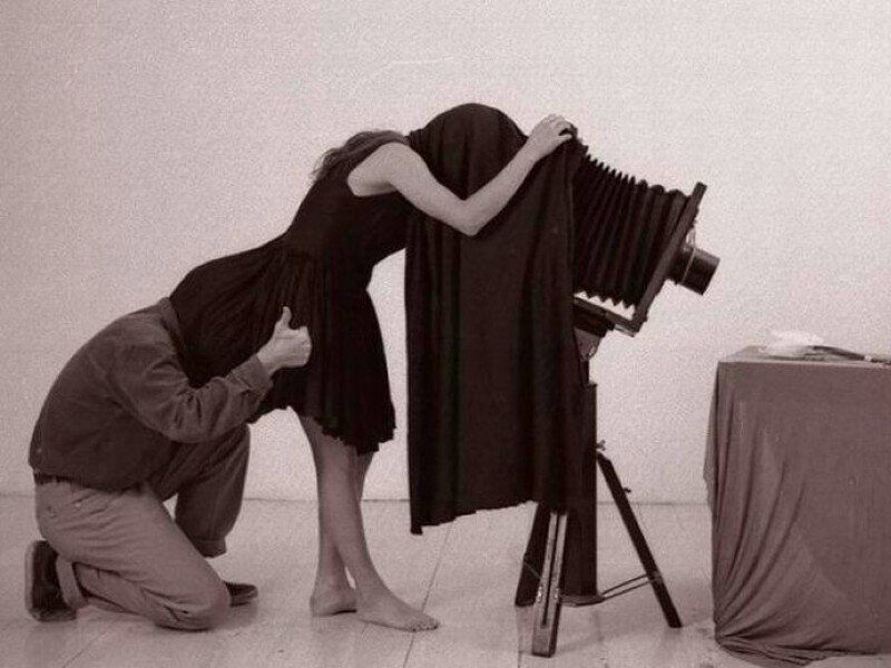 Photographer and model with large camera