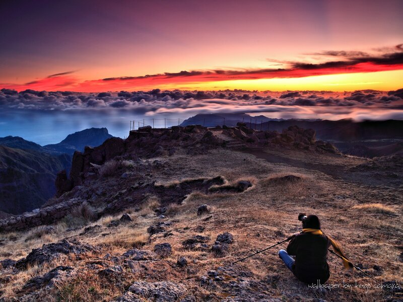 Photographer at mountain summit