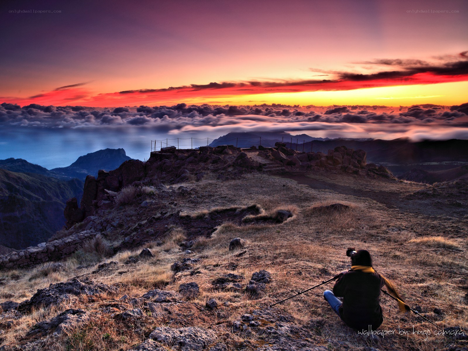 Photographer at mountain summit