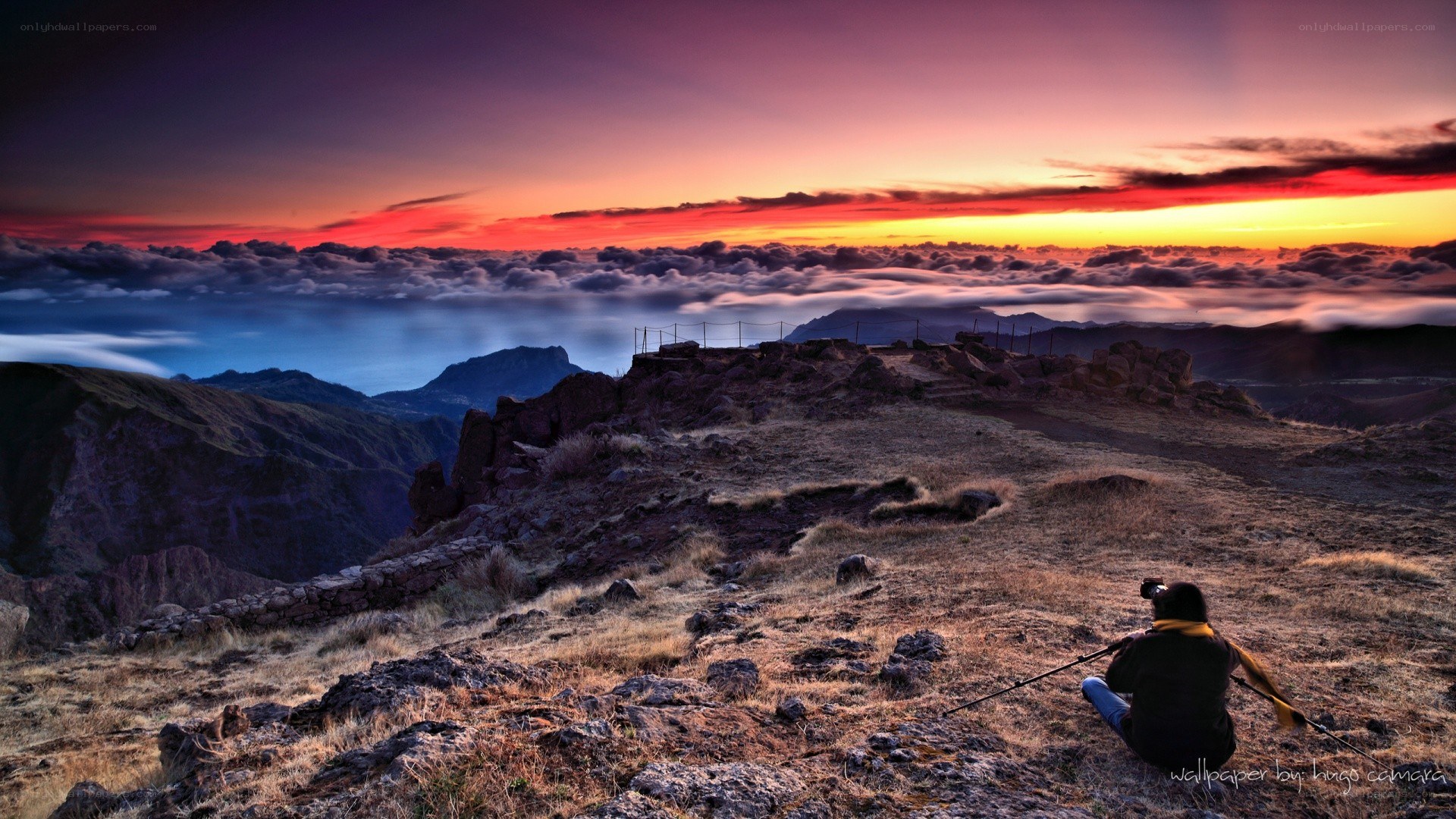 Photographer at sunset on a mountain
