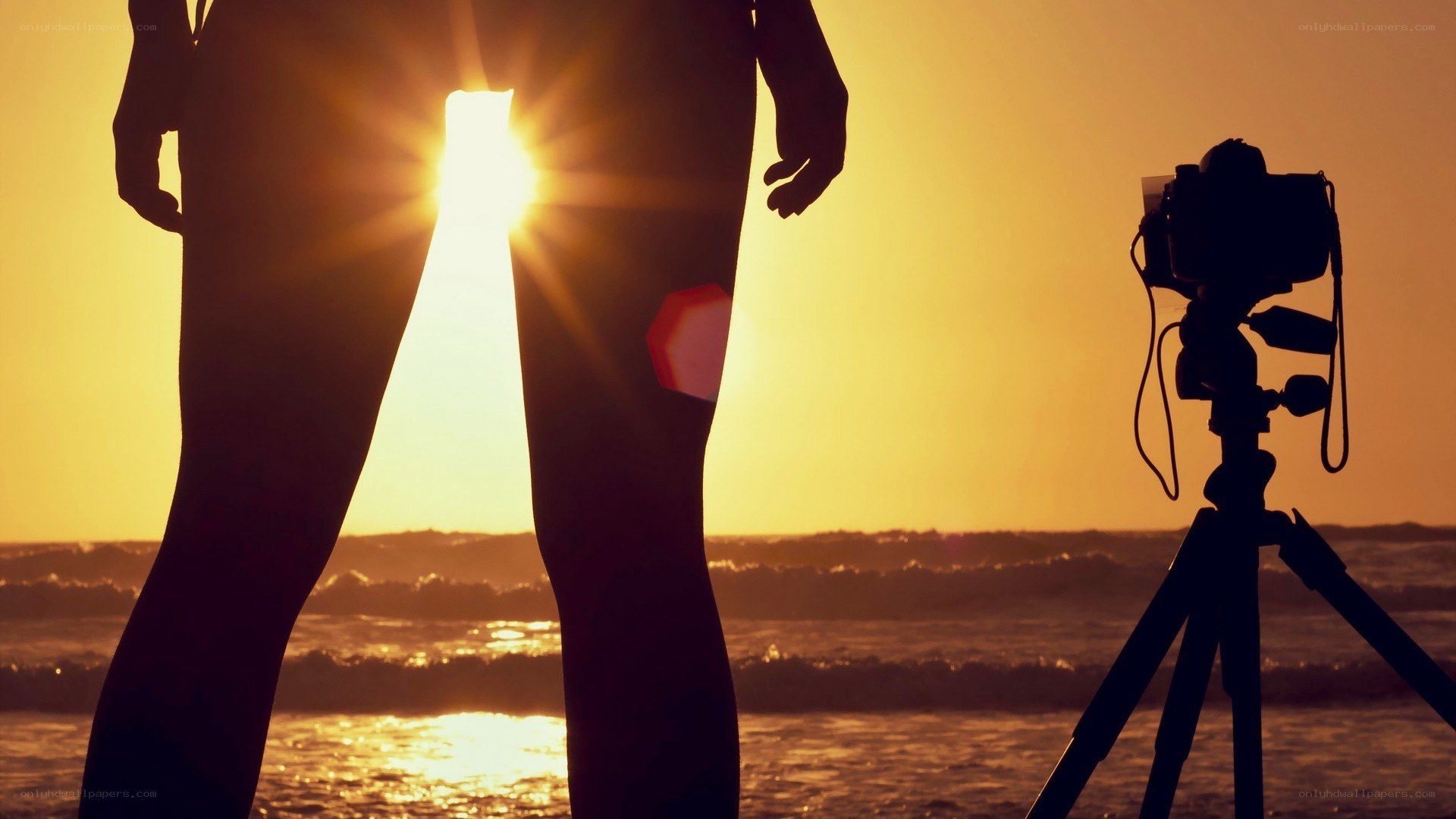 Photographer at sunset on beach