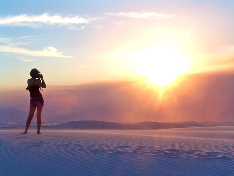 Photographer at sunset on sand dunes