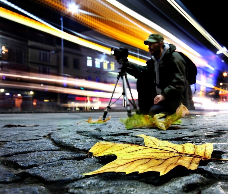 Photographer capturing light trails at night