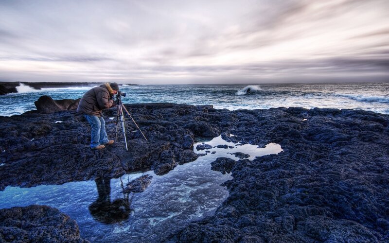 Photographer on rocky shore