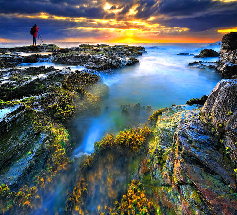 Photographer on Rocky Shore — Blue